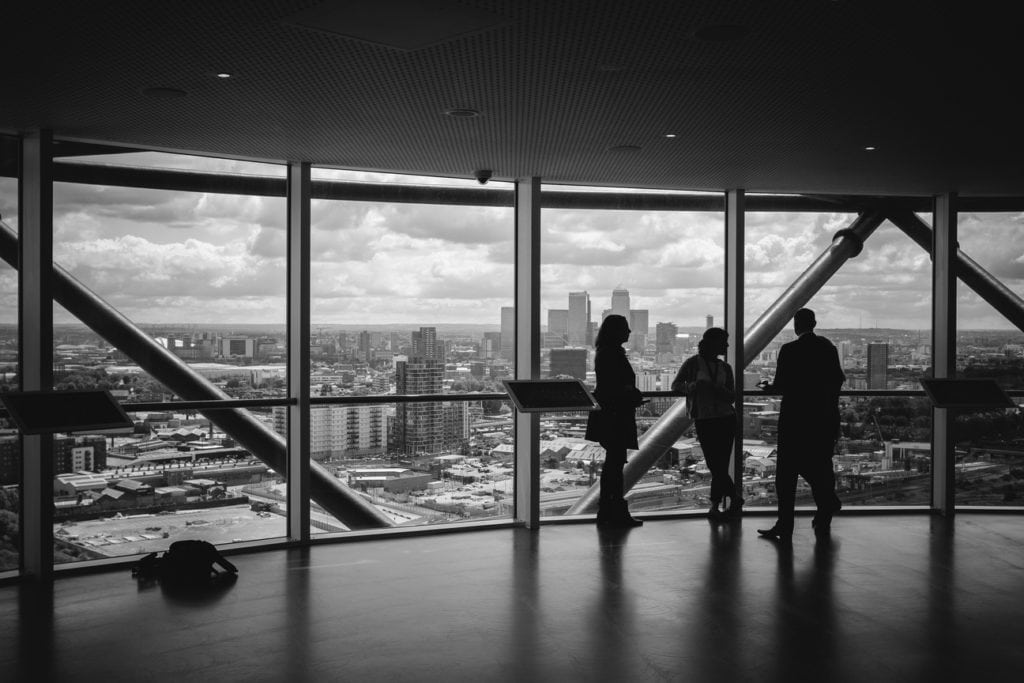 Silhouetted figures in high-rise office