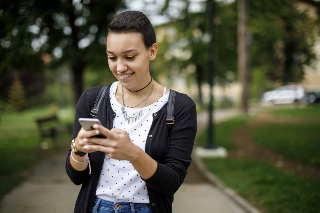 College student on phone outside