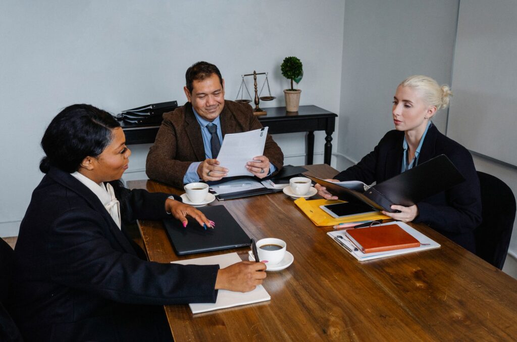 Office workers sitting around a table iin a meeting