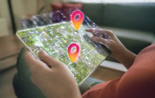 hands-holding-tablet-displaying-interactive-maps-of-city-blocks-with-two-location-indicators