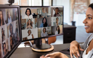 woman working remotely on video call with diverse coworkers