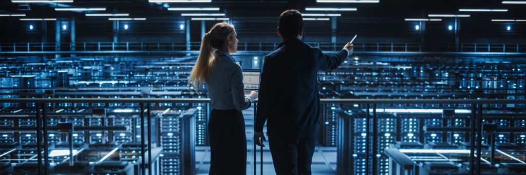 Two professionals taking tour of data center