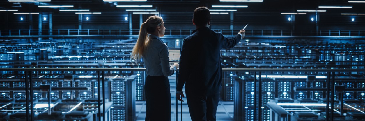 two professionals taking tour of data center