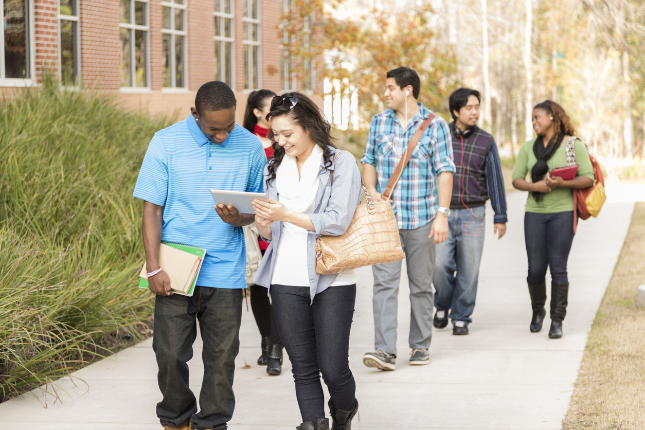 College students easily navigating campus by using a tablet and interactive map built with digital accessibility principles