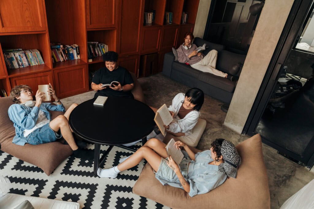 Group of friends studying in a mid-sized room after reserving the room though university room scheduling software