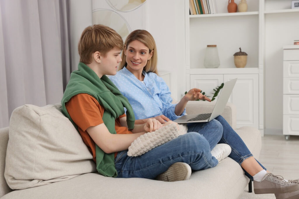 Parent and teenager touring a campus online and experiencing the benefits of virtual campus tours