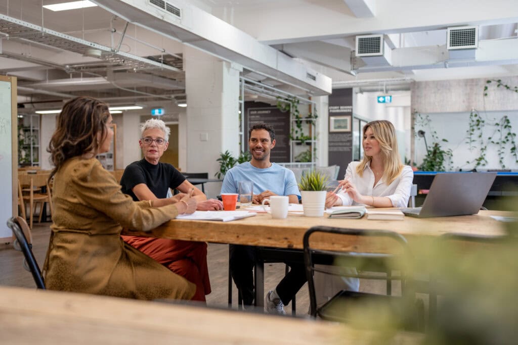 College admissions team discussing new tactics for managing admissions expenses