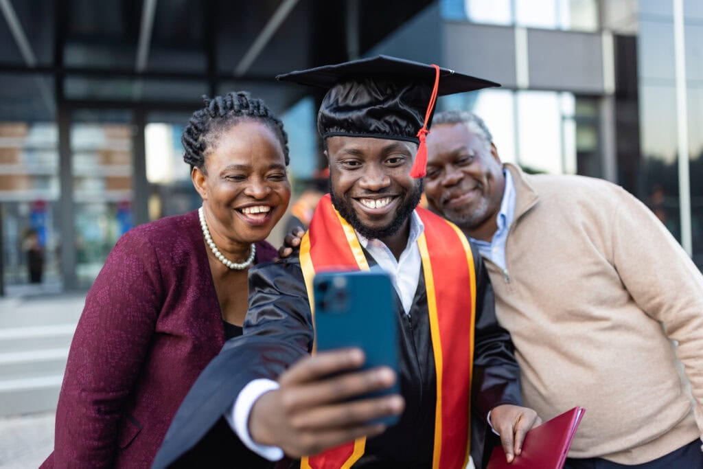 College graduate enjoying Commencement Day with his parents