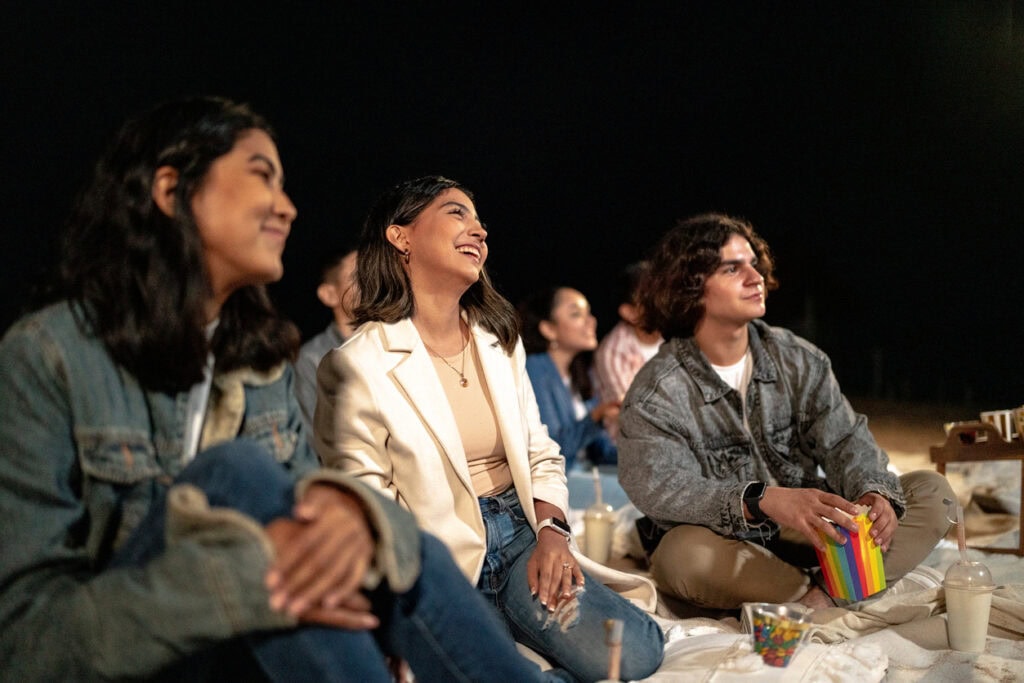 Students attending late-night student programs like an outdoor movie night