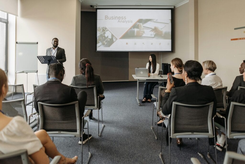 College classroom with students focused on the professor at the front of the room.