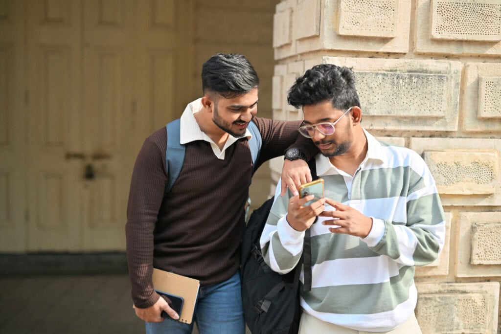 Students sharing details about Welcome Week events they found on their phone