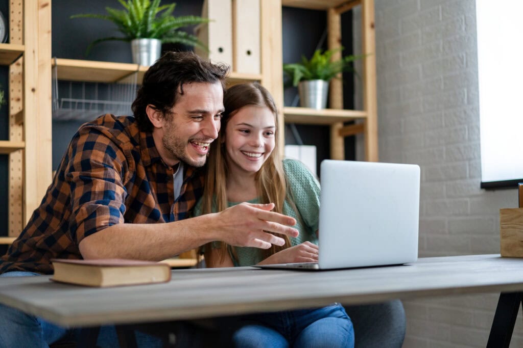 Teenager and parent showing interest in interactive maps in admissions campaigns