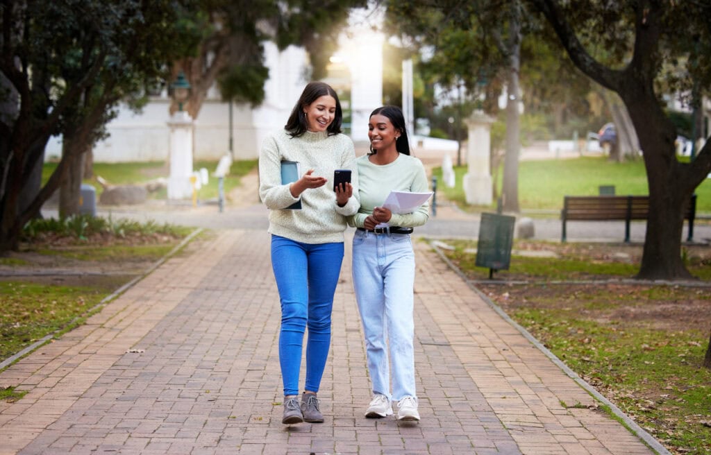 Two prospective students looking at an interactive campus map for visitors