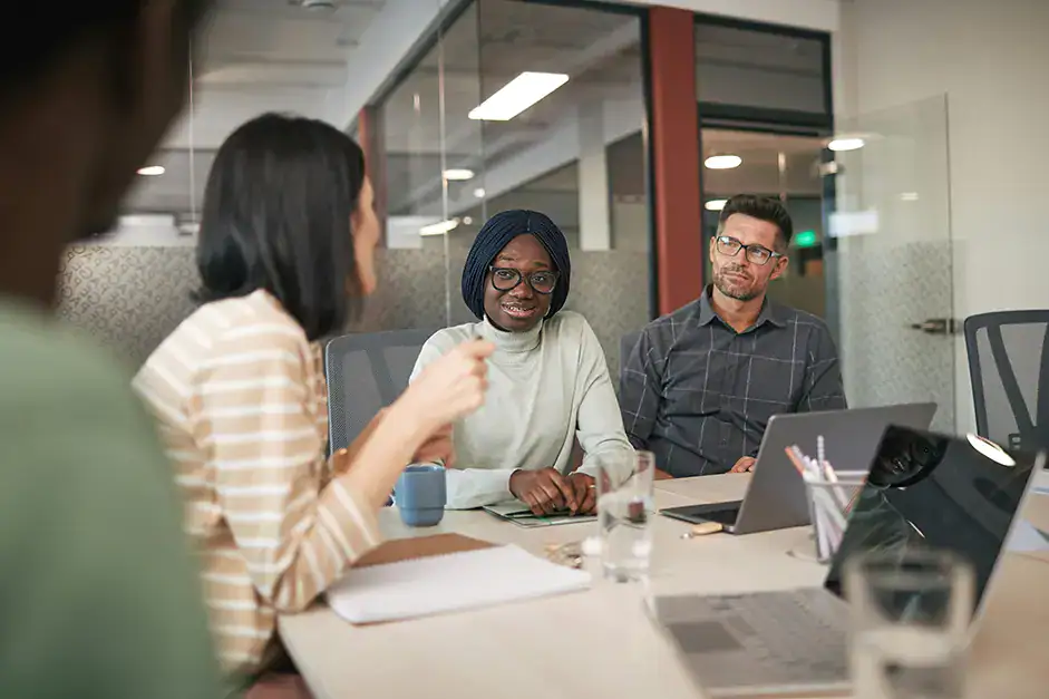 3 higher ed workers brainstorming together at a table
