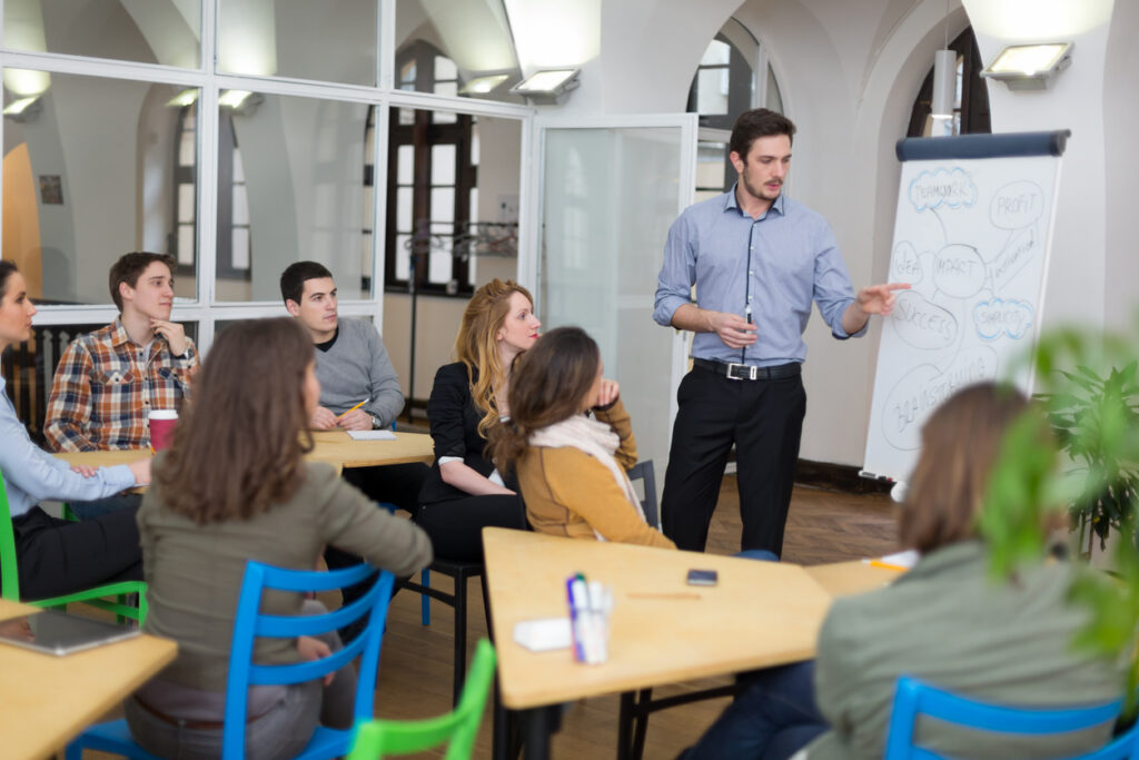 Staff having a productive meeting in a right-sized university space due to easy room scheduling software