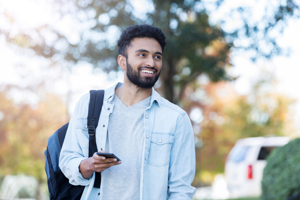 Prospective student using his phone to reach university wayfinding tools