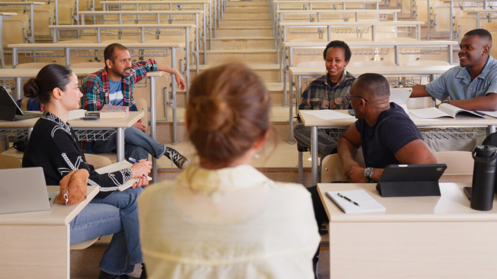Small group holding a meeting in a large classroom due to poor  classroom utilization policies