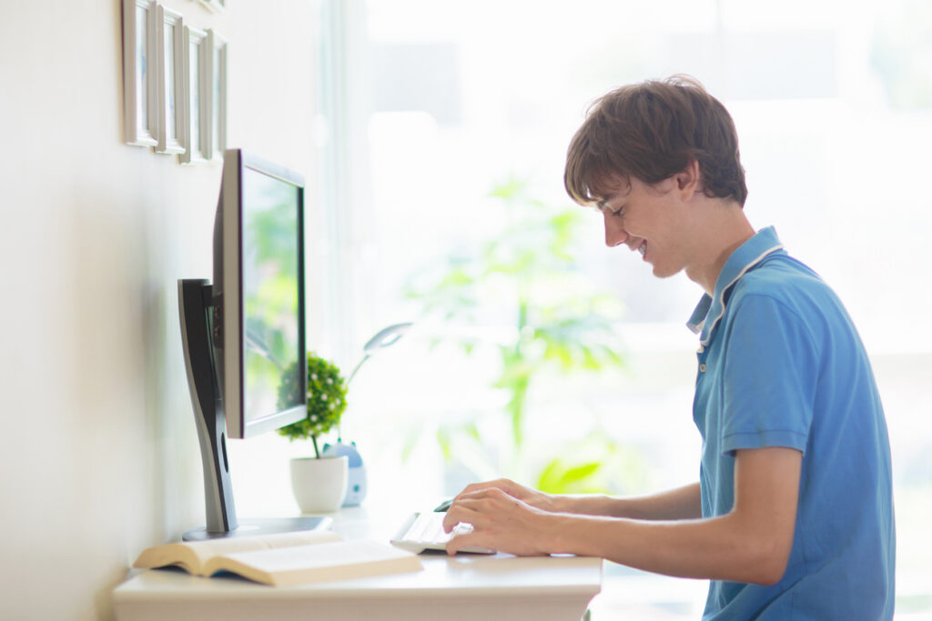 Graduating senior looking at a college website to learn more about the campus and daily life